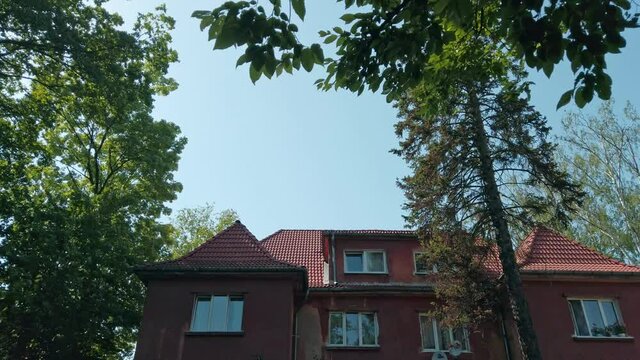 Low angle looking up view of attic floor of old residential building - landmark of german prussian architecture in historical city center of Kaliningrad, Russia (formerly Koenigsberg) rendered in 4K