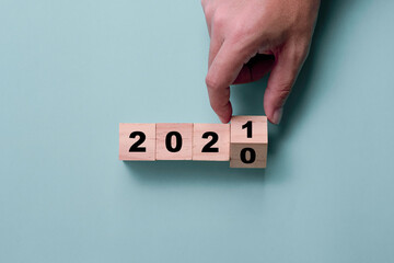 Hand flipping wooden cubes block for change 2020 to 2021.  Happy new year to start new project and...