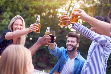 Obraz premium Friends Making Toast With Alcohol In Garden At Home Enjoying Summer Garden Party