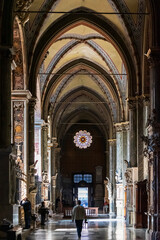 Naklejka premium Tourist exploring majestic interior of gothic cathedral in Europe