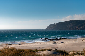 View of the scenic Guincho Beach (Praia do Guincho), with windsurfers in the sea, near Cascais, in Portugal