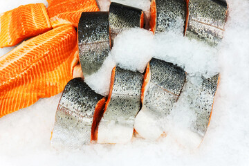 Large pieces of trout in the ice crumb. Fish on the counter in the store. Trade in seafood.