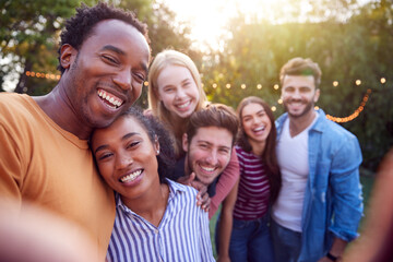 Obraz premium Group Of Multi-Cultural Friends Posing For Selfie As They Enjoy Outdoor Summer Garden Party