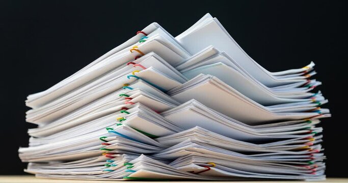 4K Stop of motion stack overload document report paper with paperclip place increase, business and education concept footage paperless used. 