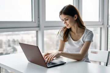 A woman sits at the office desk office