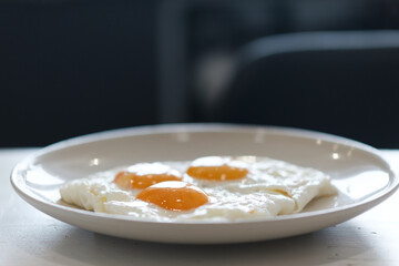 Three fried eggs for healthy breakfast.