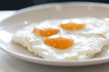 Three fried eggs for healthy breakfast.