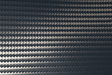 Macro photo of grey carbon fiber pattern texture surface.