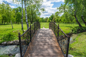 Fototapeta na wymiar wooden bridge with metal railings