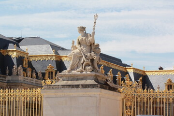 Sculpture near the golden gates of the Palace of Versailles, France