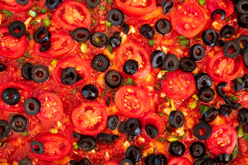 Pizza with tomatoes and black olives