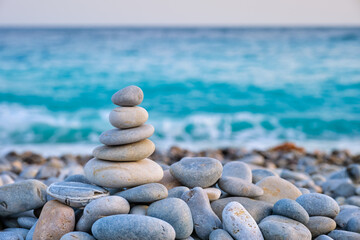 Fototapeta na wymiar Zen meditation relaxation concept background - balanced stones stack close up on sea beach