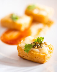 Grilled puff pastry topped with cheddar cheese & garlic butter, oregano seasoning & cilantro for garnish.
