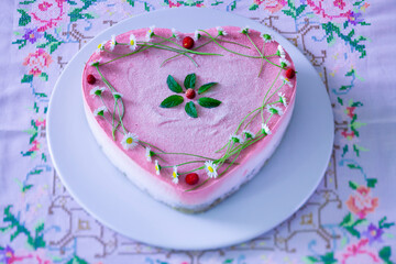 Fototapeta na wymiar Vegan and raw strawberry cake in heart shape