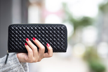woman person holding a wallet in the hand. Cost control expenses shopping in concept. Leave space...