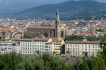 Panoramic view of the old city of Florence with buildings, houses and the Basilica of Santa Croce, known for the many tombs of great artists, writers and scientist, on a sunny day