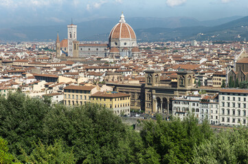 Fototapeta na wymiar Panoramic view of the old city of Florence with buildings, houses and the Cattedrale di Santa Maria del Fiore (Cathedral of Saint Mary of the Flower) on a sunny day