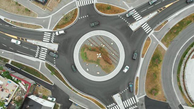 Cars Driving On The Roundabout In Arendal, Norway - aerial orbiting shot