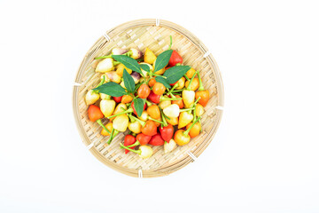 Fresh colorful peppers in a pot on white background