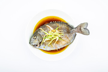 A dish of home-cooked steamed brown blue roe on a white background
