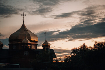 Village church on a dark warm sunset background