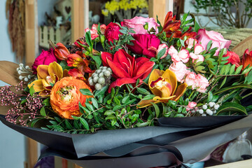Close-up shot of a beautiful and stylish bouquet of fresh various flowers in floral design studio, flower shop.