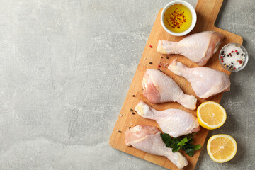 Composition with raw chicken meat on gray background, top view