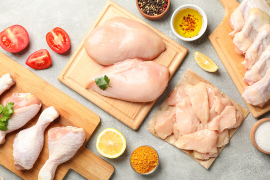 Composition with raw chicken meat on gray background, top view. Cooking chicken