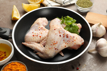 Composition with raw chicken meat and ingredients. Cooking chicken
