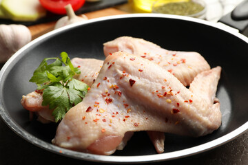 Composition with raw chicken and spices on gray background. Cooking chicken