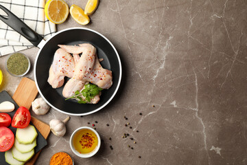 Composition with raw chicken and spices on gray background. Cooking chicken