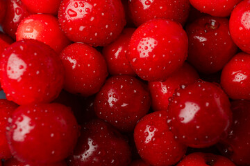 Fresh red cherry with water drops on whole background, close up