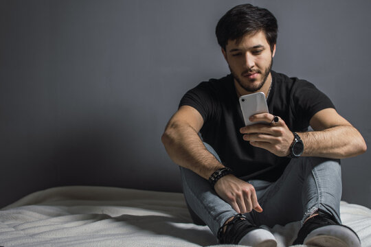 handsome young man using his smart phone