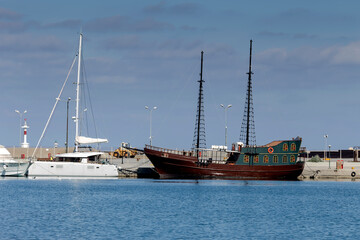 Tourist pirate ship approached the shore (island Crete, city Rethymno) on a sunny winter day (Greece)