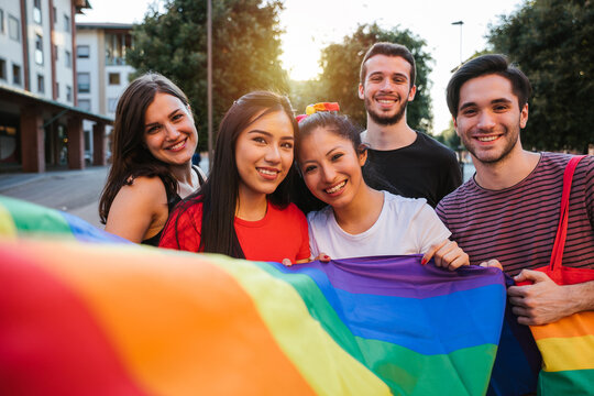 Portrait Group Of Young People Demonstration For Rights At The Gay Pride In The City - Millennial Holding A Flag Colorful - Supporters Of The LGBT Community - Concept Shooting Of Equality Social