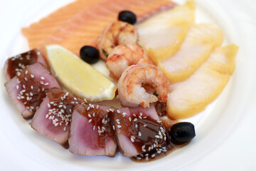 Slices salted fishes with lemon