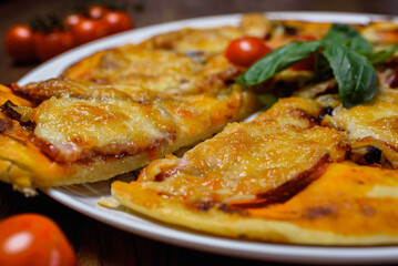 
pizza with meat and tomatoes under cheese