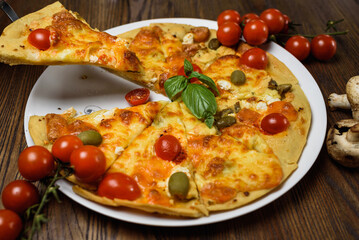 
pizza with meat and tomatoes under cheese