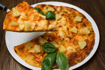 
pizza with meat and tomatoes under cheese