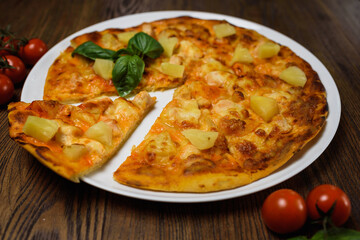 
pizza with meat and tomatoes under cheese