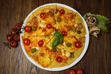 
pizza with meat and tomatoes under cheese