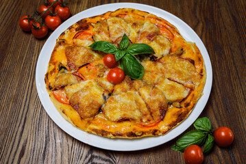 
pizza with meat and tomatoes under cheese