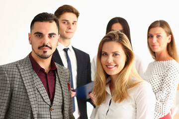 Portrait of smiling business people standing together at startup in their office. Creative business team concept