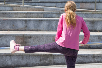 woman doing gymnastic exercises on the street