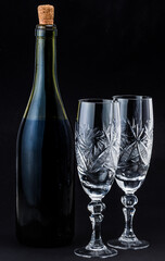 bottle of wine and glasses on a dark background