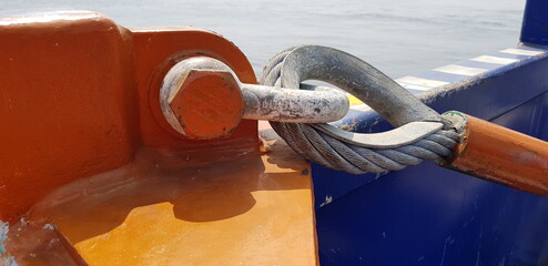 view of pad eyes attached with shackles, safety pin and sling wire on open top tray basket for...