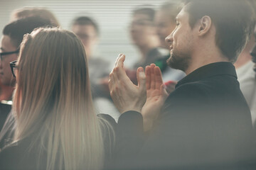 through the glass. a group of young business people applauding
