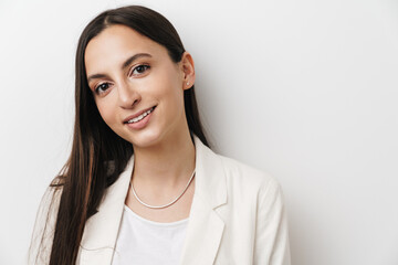 Photo of young pleased businesswoman smiling and looking at camera