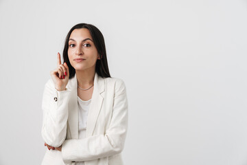 Photo of businesswoman pointing finger upward and looking at camera