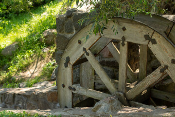 old wooden water pumping wheel on the river